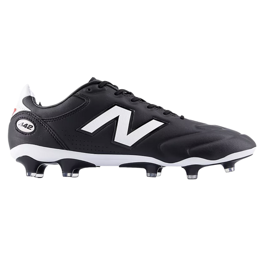 A side view of a black New Balance 442 soccer boot featuring a large white logo, a white midsole, and black studs with clear tips against a solid black background.