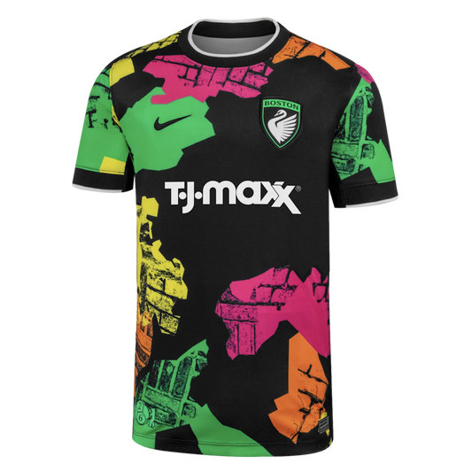 Black Nike soccer jersey with a 'BOSTON' swan crest, T.J. Maxx sponsor, and a bold, colorful abstract pattern of textured shapes in green, pink, and orange.