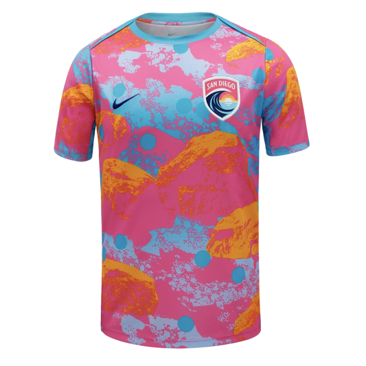 A Nike San Diego Wave FC jersey with a vibrant pink, light blue, and orange abstract pattern. It features the team crest and a dark blue swoosh on the chest.