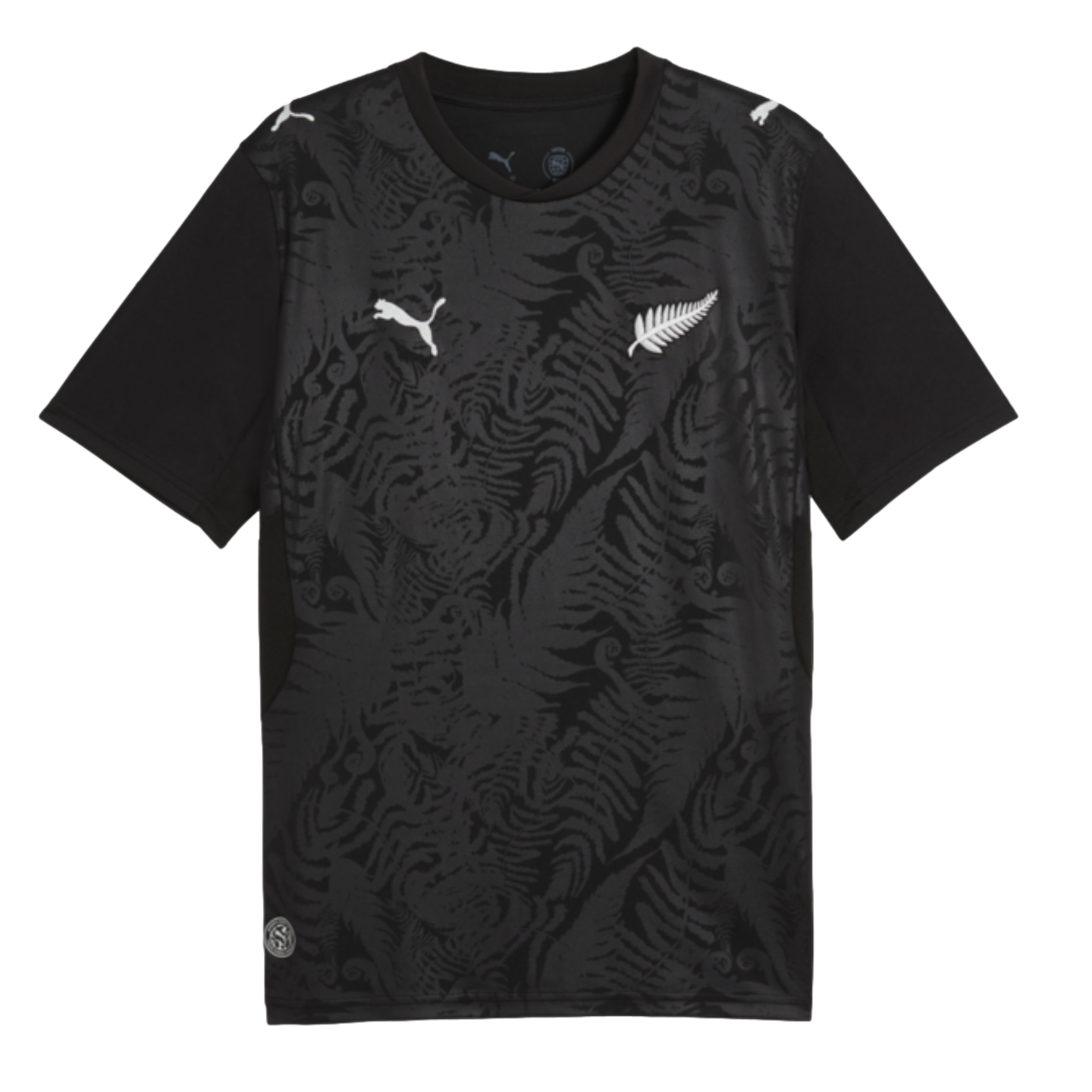 A black Puma t-shirt with a tonal fern pattern, featuring white Puma cat logos on the chest and shoulders, and a white silver fern emblem on the left chest.