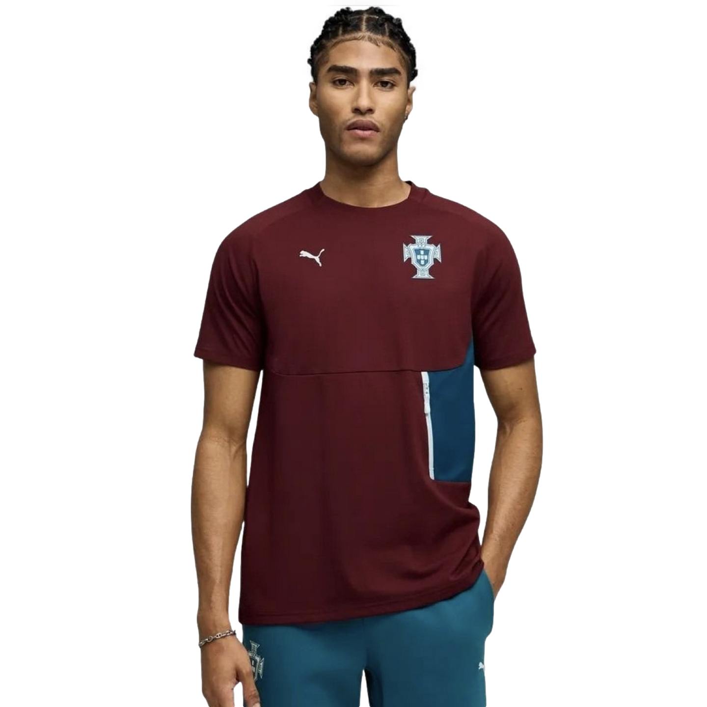 A young man with braided hair models a maroon Puma short-sleeve shirt featuring the Portugal national team crest and a teal side pocket detail, set against a solid black background.