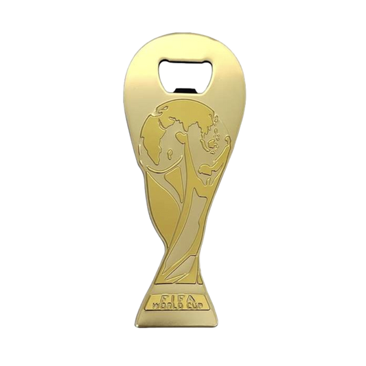 A gold-colored bottle opener shaped like the FIFA World Cup trophy, featuring the trophy's design embossed on the front and the words "FIFA WORLD CUP" engraved at the base.
