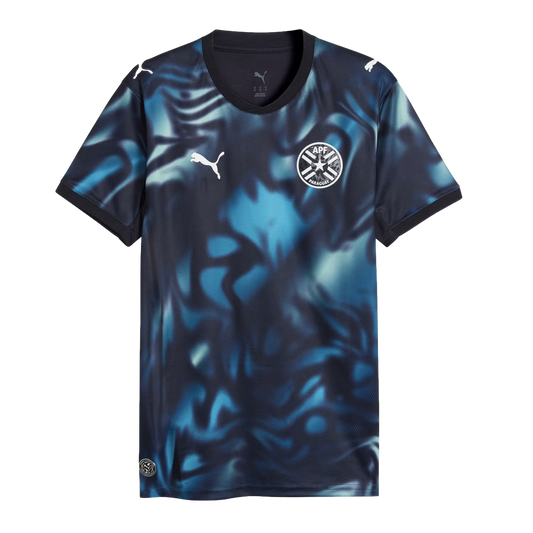Puma Paraguay national team soccer jersey featuring a dark navy and blue abstract swirl pattern, white Puma logos, and the APF team crest.