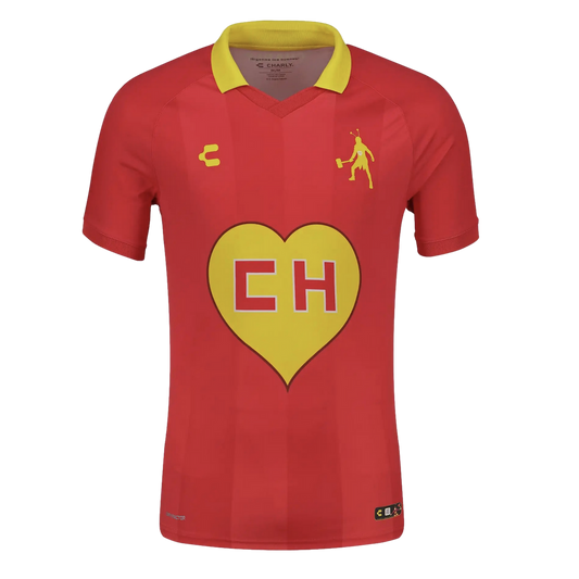 Red Charly soccer jersey with a yellow collar, featuring a large yellow heart with "CH" on the chest and a yellow silhouette of El Chapulín Colorado on the upper left.