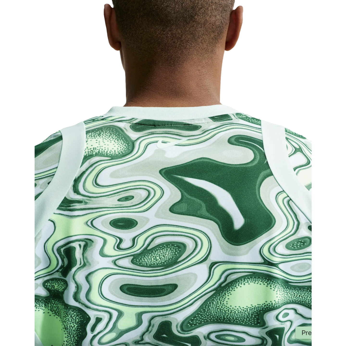 Rear view of a person wearing a Nike top featuring a green and white marbled topographic pattern and white shoulder trim.