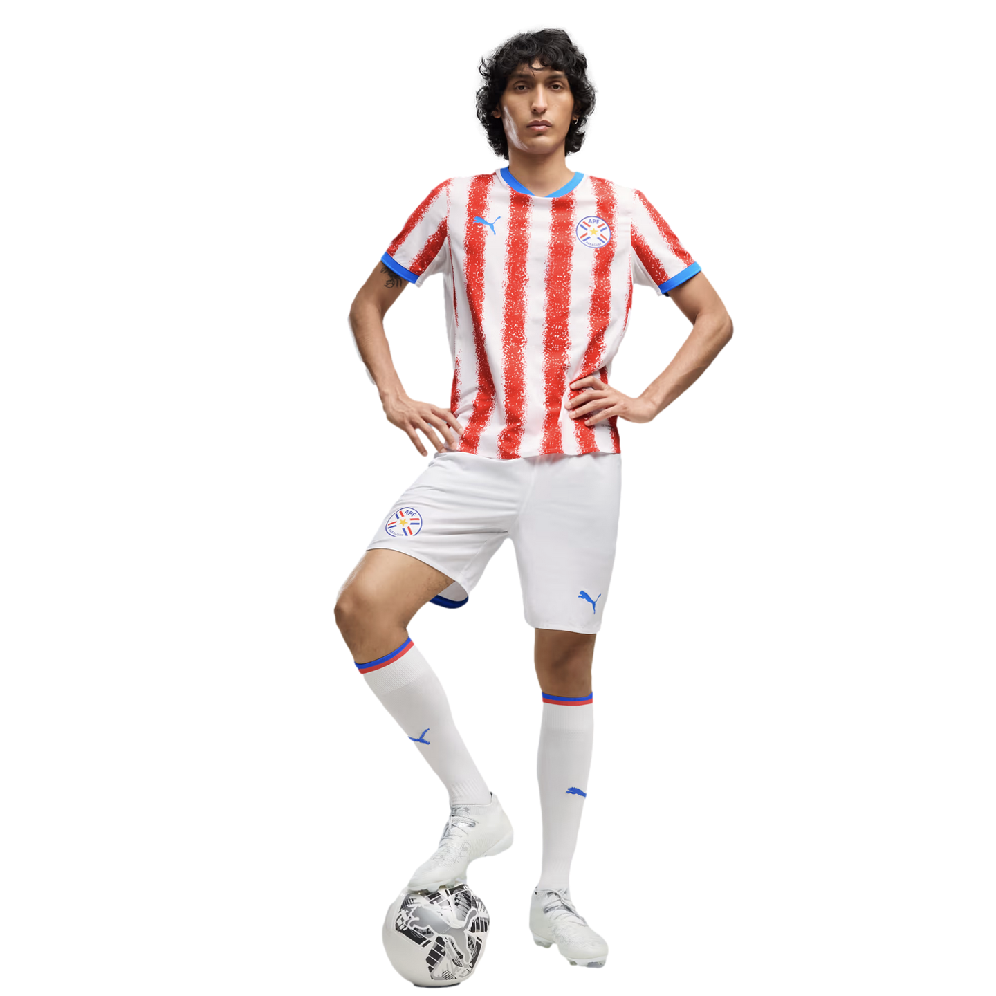 A man in a red and white striped Paraguay national team soccer uniform posing with a soccer ball against a white background.