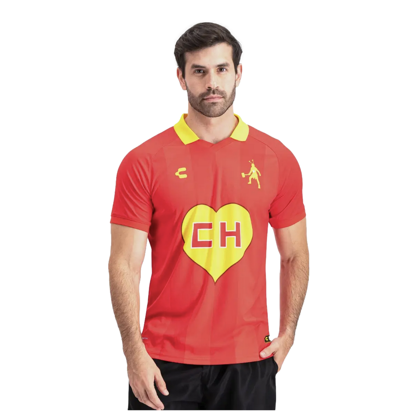 A man with a beard wearing a red jersey with a yellow collar and a large yellow heart centered with red "CH" letters. He stands against a white background with one hand in his pocket.